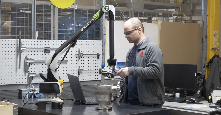 White safety helmet hanging in an industrial setting, representing HSE and quality standards
