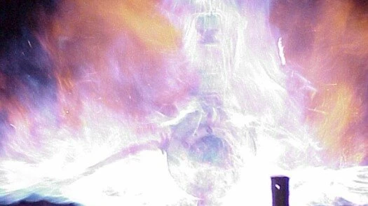 A bright explosion flash fills the frame, with glowing white and purple light and sparks bursting upward.