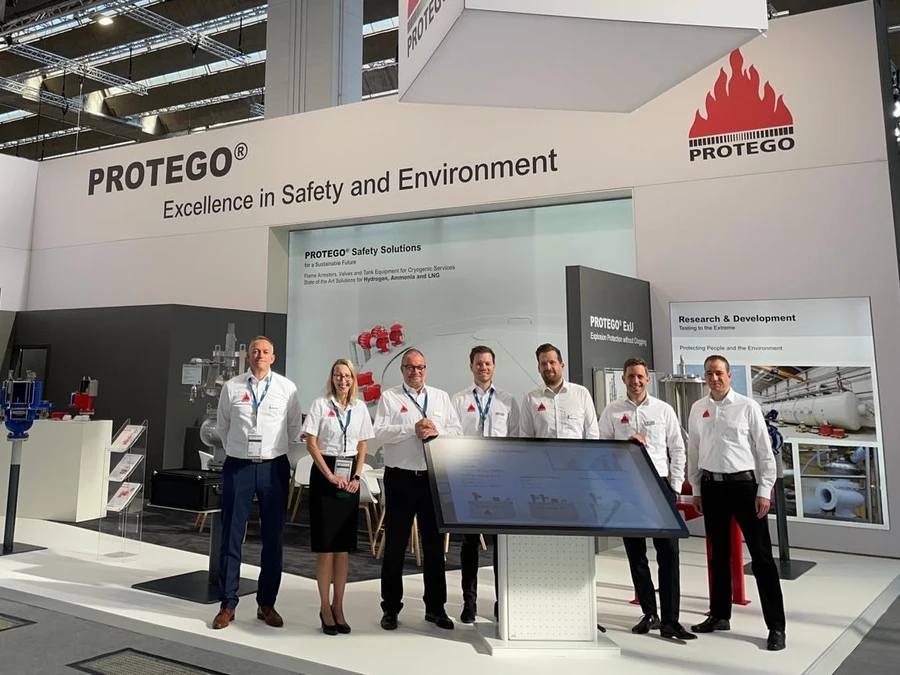 PROTEGO® team at a trade show booth, showcasing safety and environmental solutions with a focus on research and development.
