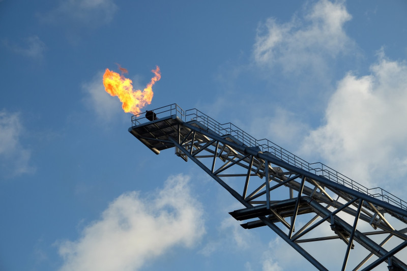 Industries OEM and equipment makers, featuring a flare stack emitting flames against a blue sky